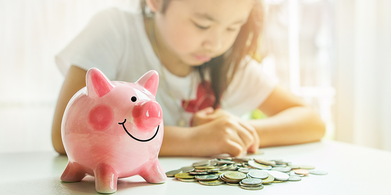 Girl with piggy bank and coins