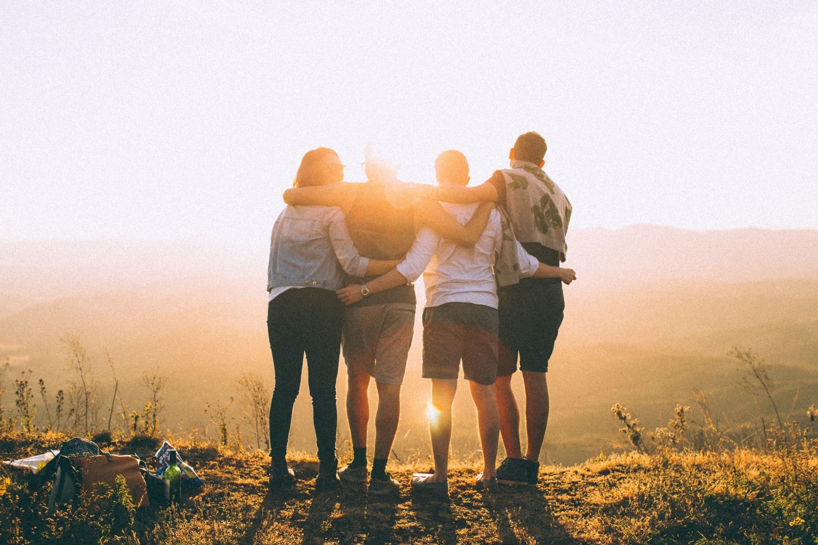 Friends on top of mountain with sunset