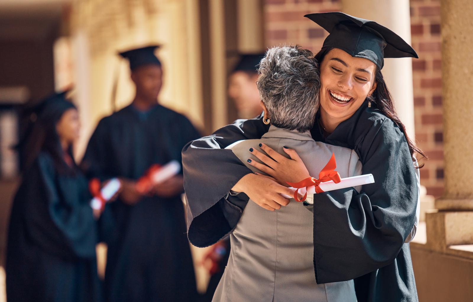 College graduate hugging a relative