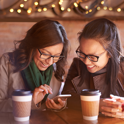 two girls looking at a phone