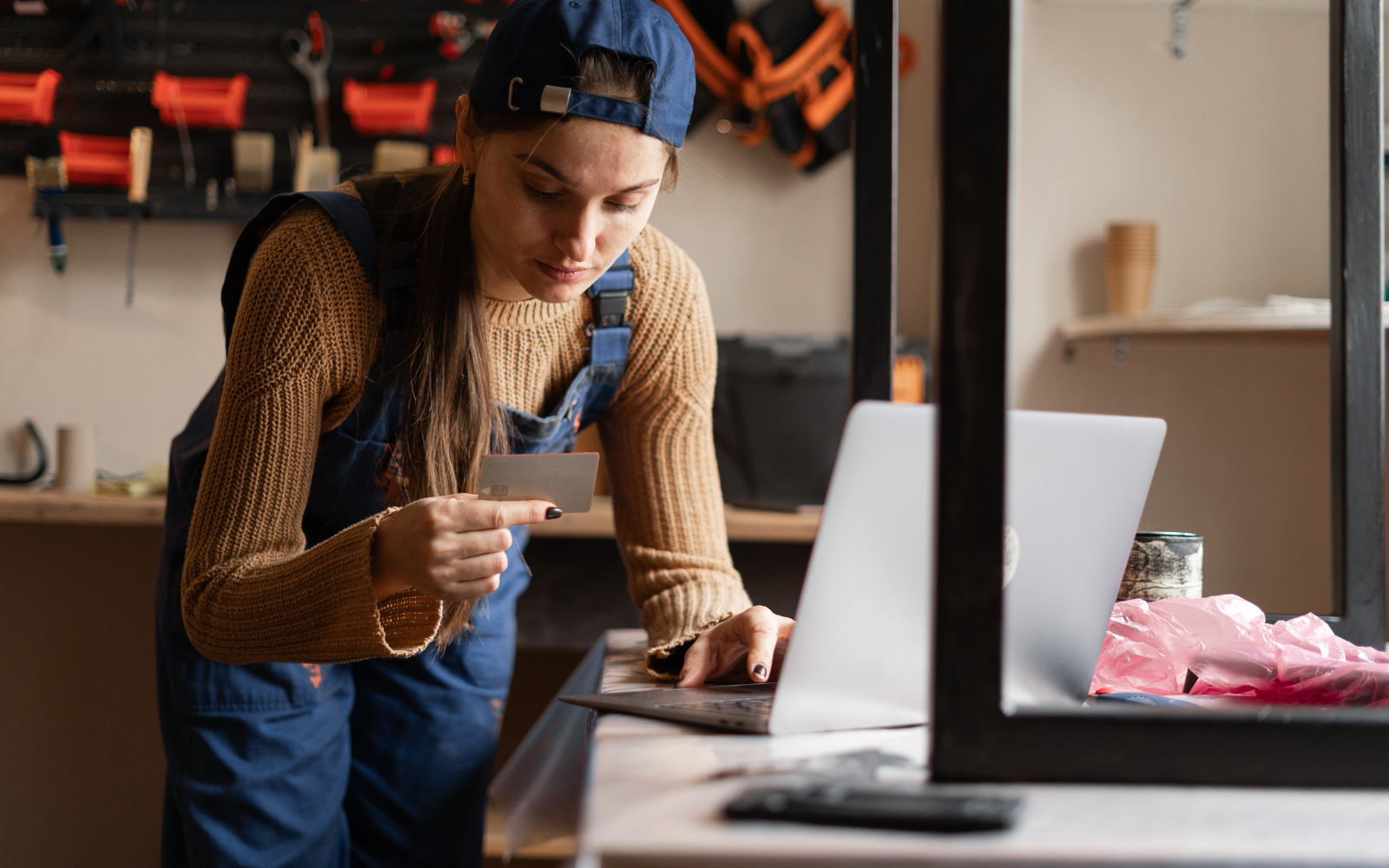 Woman making a secure transaction on her laptop with a credit card