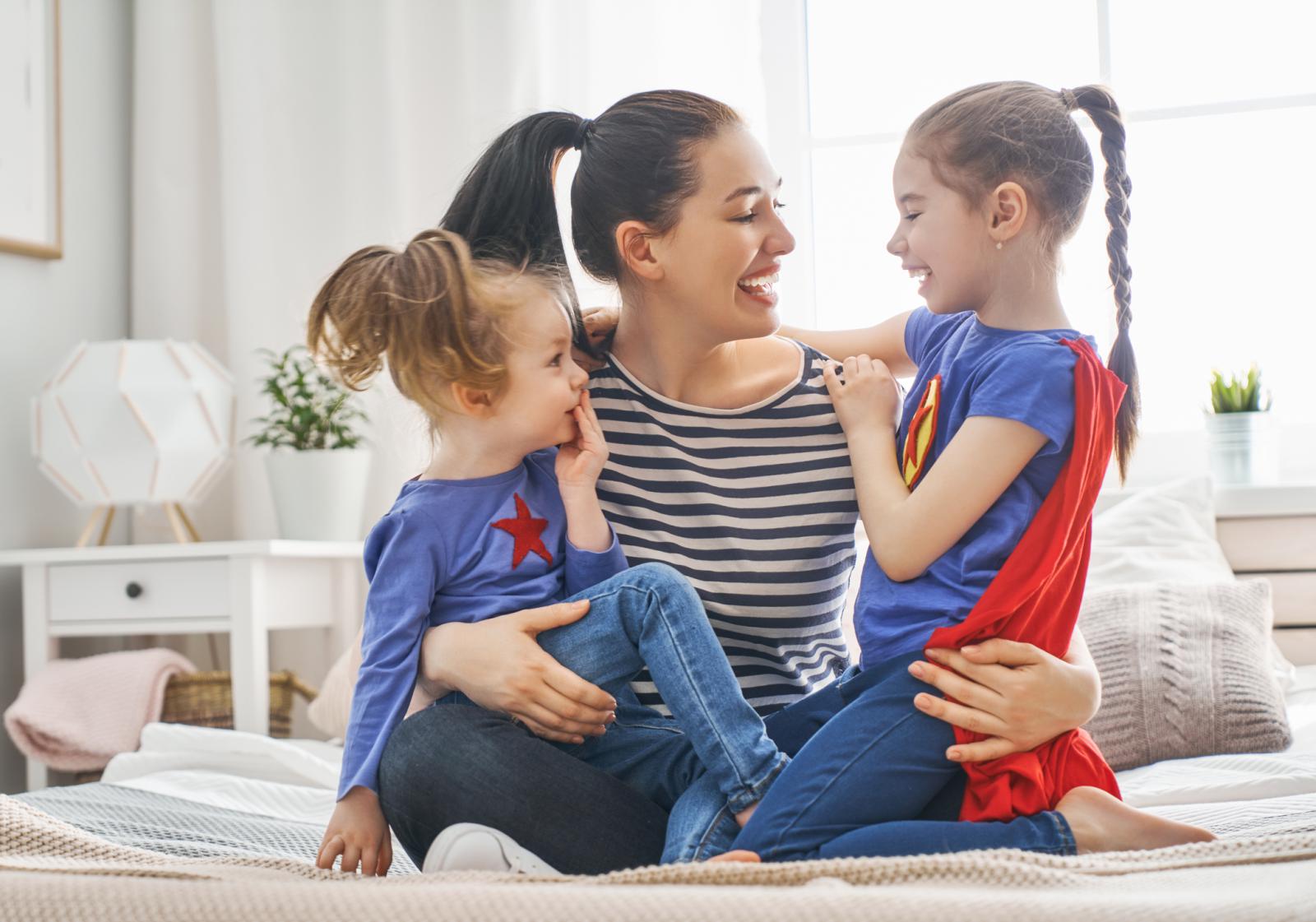 Woman with two daughters laughing