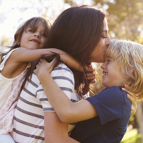 mom kissing child's forehead